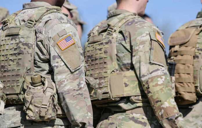 Soldiers in camouflage uniforms with American flag patches.