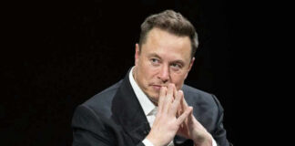Elon Musk in suit thinking.