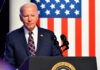 Biden’s Security Detail Scandal Revealed Joe Biden speaking at a podium with US flag background.