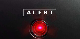 Red alert light against black background, text ALERT.
