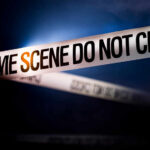 Teen Brawl Ends in Mass Shooting Police tape reading 'CRIME SCENE DO NOT CROSS' in a dark setting