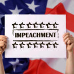 Iran War Triggers Impeachment Filing Hands holding impeachment sign over American flag.