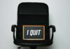 An office chair with a framed sign that says 'I QUIT'