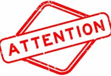 Trump Arch Bombshell Hits Lincoln Views Red attention sign with the word 'ATTENTION' in bold letters