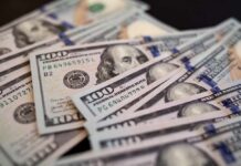 Close-up of scattered hundred dollar bills