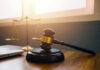 Gavel and scales of justice on desk.