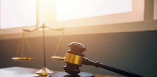Gavel and scales of justice on desk.