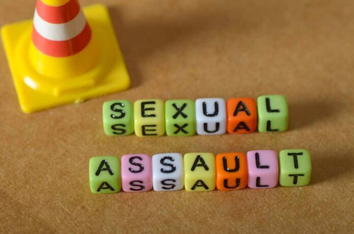 Colorful letter blocks spelling out 'SEXUAL' and 'ASSAULT' next to a traffic cone