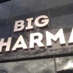 Big Pharma BENDS to Trump’s Demand Sign displaying the words BIG PHARMA on a glass building