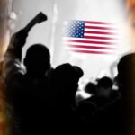 Trump Pushes ‘NICE’ — Leftists Explode Silhouetted crowd with raised fists in front of an American flag and flames