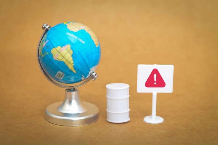A miniature globe next to a warning sign and a barrel