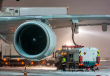Jet Fuel SHOCK — Airlines Will Slash Summer Flights Ground crew fueling an aircraft during snowy weather
