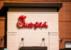 Chick-fil-A restaurant sign on a brick wall