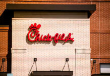 Chick-fil-A restaurant sign on a brick wall