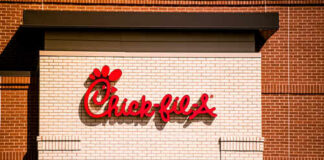 Chick-fil-A restaurant sign on a brick wall