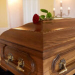 Dying Daughter’s Final Wish Motivates Senator A wooden casket with a red rose placed on top