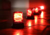 Panic Chaos: Festival Stampede Injures 19 Red emergency lights on dark floor, illuminating the area.