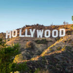 Celebrity Helper Exposed in Fatal Addiction Scandal Hollywood sign on a sunny hillside.