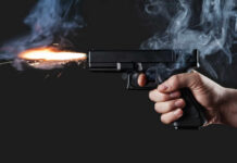 Campus Mass Shooting: 259 Years Looms A hand holding a gun with smoke and a flash from the muzzle