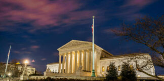 The United States Supreme Court building at dusk.