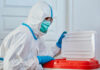 American Doctor Catches Ebola in Congo Healthcare worker in protective gear disposing of waste