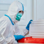 American Doctor Catches Ebola in Congo Healthcare worker in protective gear disposing of waste