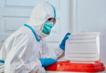 American Doctor Catches Ebola in Congo Healthcare worker in protective gear disposing of waste