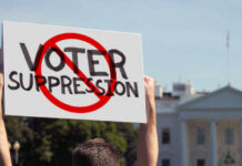 Voter Suppression Scandal: SHOCKING Map Fight Person holding No Voter Suppression sign outside White House.