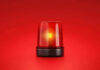 Red emergency light on solid red background.