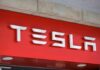 Tesla logo displayed on a red background