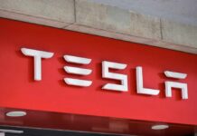 Tesla logo displayed on a red background