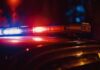 Shocking Dive Disaster: What Went Wrong? Close-up of a police car's emergency lights at night