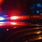 Shocking Dive Disaster: What Went Wrong? Close-up of a police car's emergency lights at night