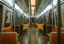 Subway Surfing Tragedy: Teen Falls to Death Empty subway train with orange seats.