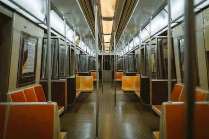 shutterstock_2255699087 Empty subway train with orange seats.