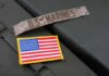 Military patches including a US Marines insignia and an American flag on a green surface
