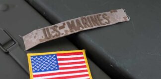 Military patches including a US Marines insignia and an American flag on a green surface
