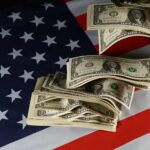 Dollar bills arranged on an American flag