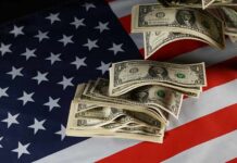 Dollar bills arranged on an American flag
