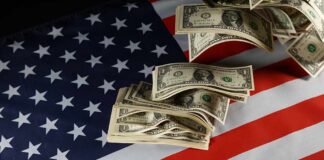Dollar bills arranged on an American flag