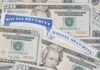 A collection of twenty-dollar bills and social security cards