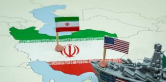 A map of Iran with flags of Iran and the United States and a toy military ship
