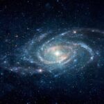 Frozen World Breathes — Scientists Can’t Explain How A spiral galaxy surrounded by stars in a dark space background