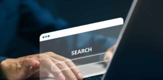 Person typing on a laptop with a search bar overlay