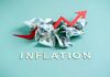 Crumpled dollar bills with a red upward arrow and the word 'INFLATION'