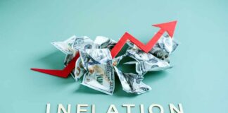 Crumpled dollar bills with a red upward arrow and the word 'INFLATION'
