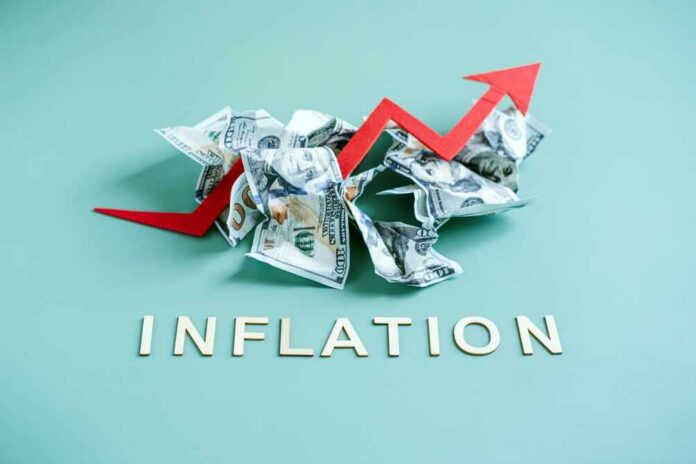Crumpled dollar bills with a red upward arrow and the word 'INFLATION'