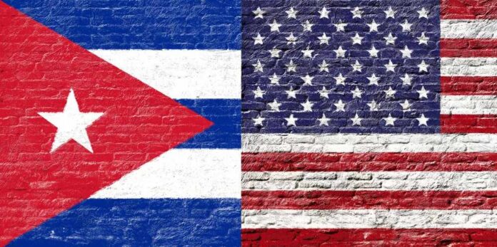 shutterstock_321802142 Cuban and American flags painted on a brick wall