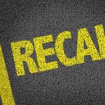 RECALL: Brake Glitch On 421,000 Vehicles Yellow 'RECALL' text on a dark asphalt surface