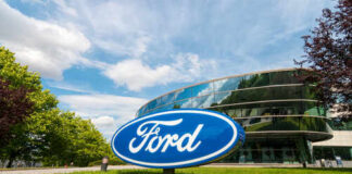 Ford logo in front of a modern corporate building